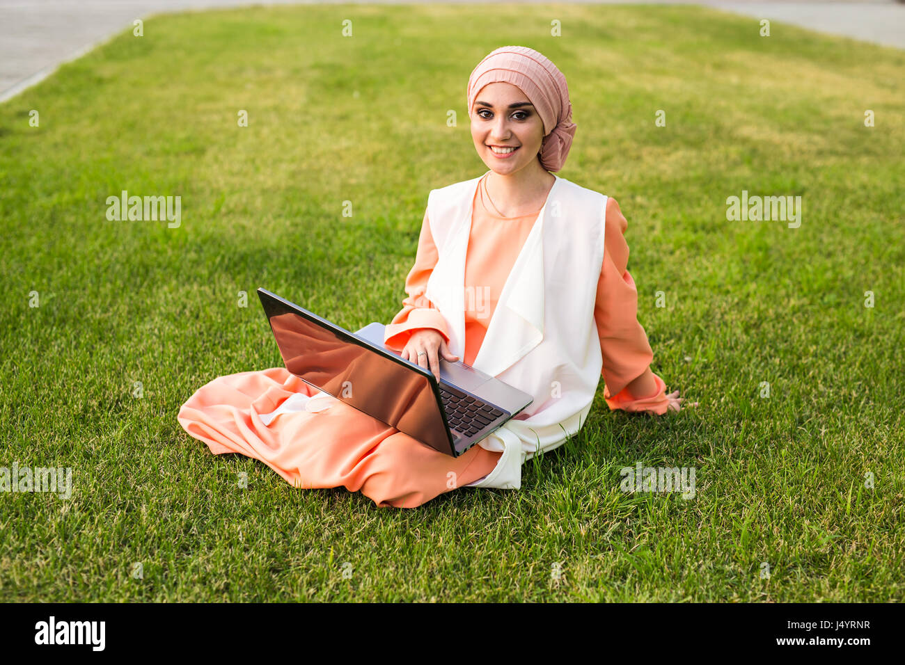 Young Muslim Girl using laptop Stock Photo - Alamy