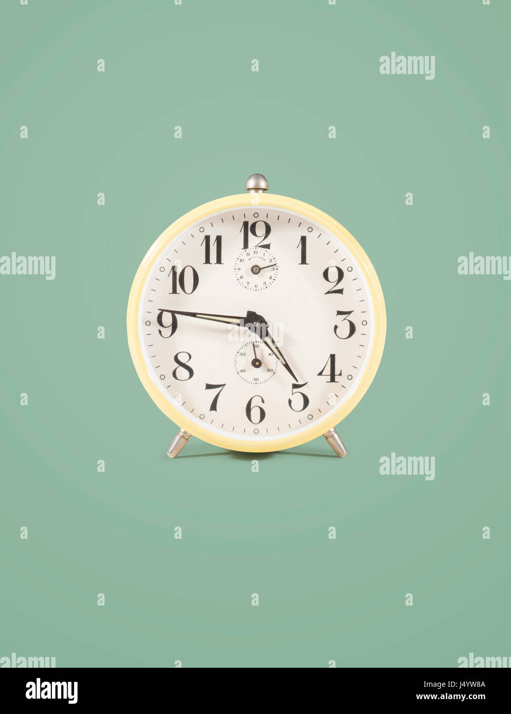 isolated retro alarm clock on colored background Stock Photo - Alamy