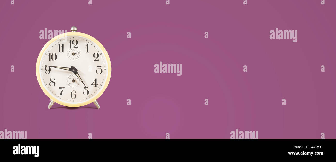 Clock Header retro alarm clock header on colored background Stock Photo - Alamy