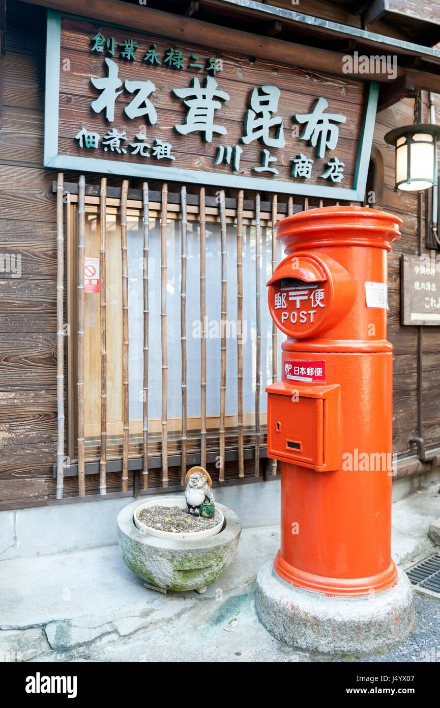 Kobe, Japan - March 2016: Old Japanese postbox stands beside a street in the hot spring village of Arima Onsen in Kobe, Japan Stock Photo