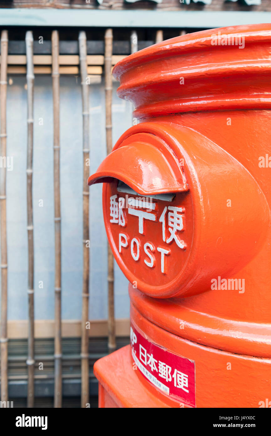 Kobe, Japan - March 2016: Old Japanese postbox stands beside a street in the hot spring village of Arima Onsen in Kobe, Japan Stock Photo
