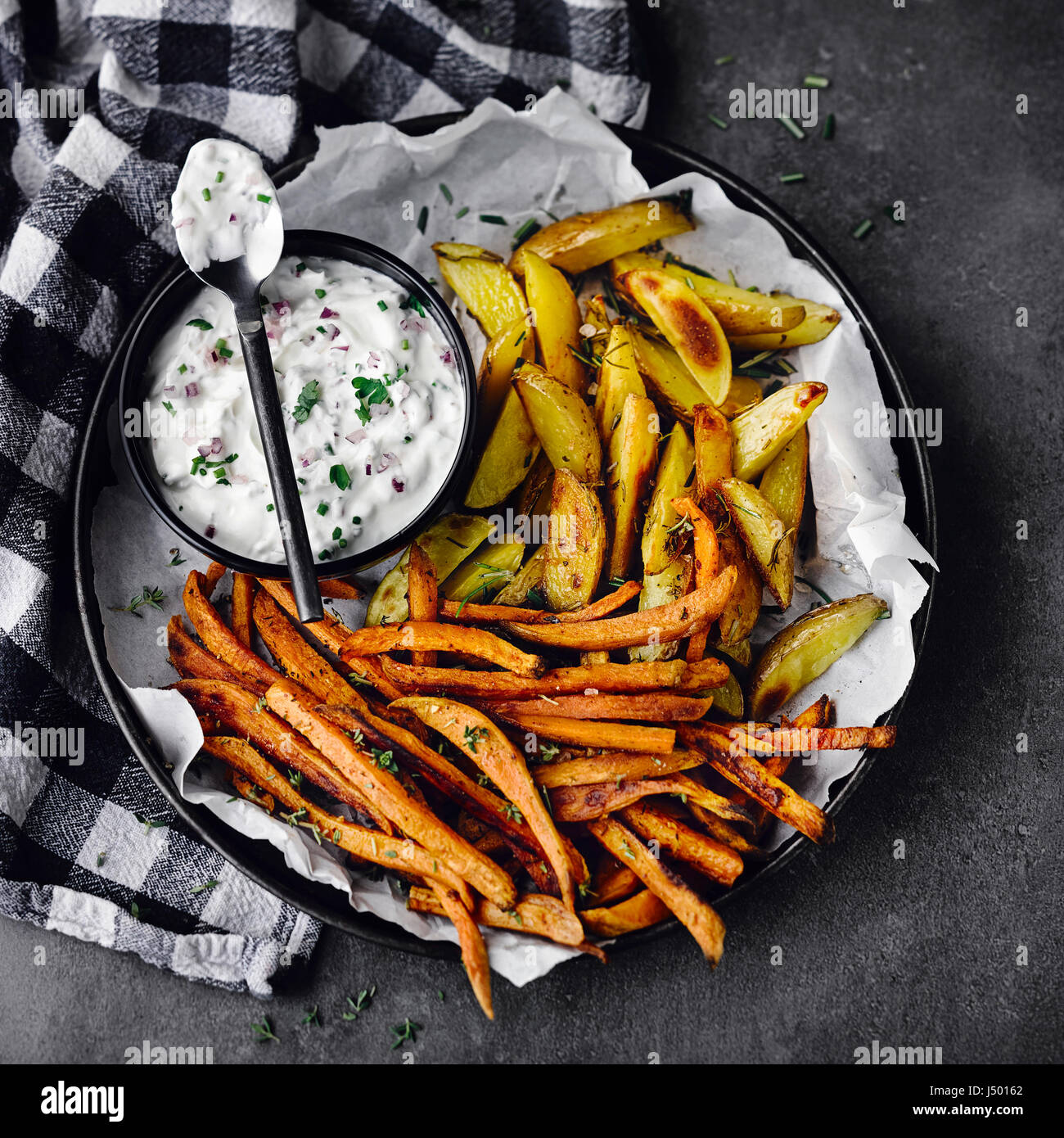 Two sorts of oven potatoes with herbal quark Stock Photo