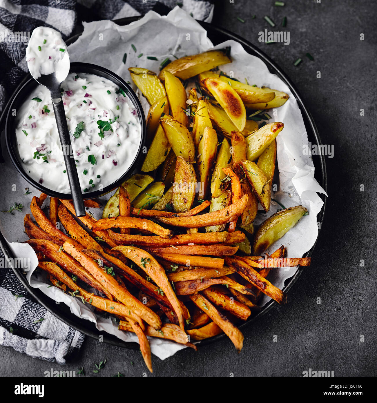 Two sorts of oven potatoes with herbal quark Stock Photo