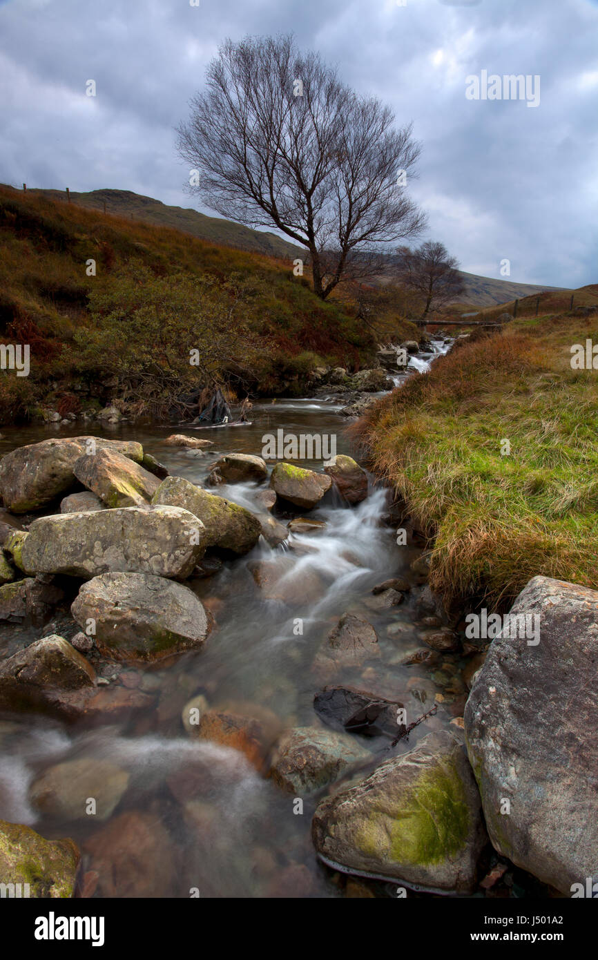 A close up, long exposure view of the rocky stream at the head of Seatoller pass in the English Lake District National Park Stock Photo