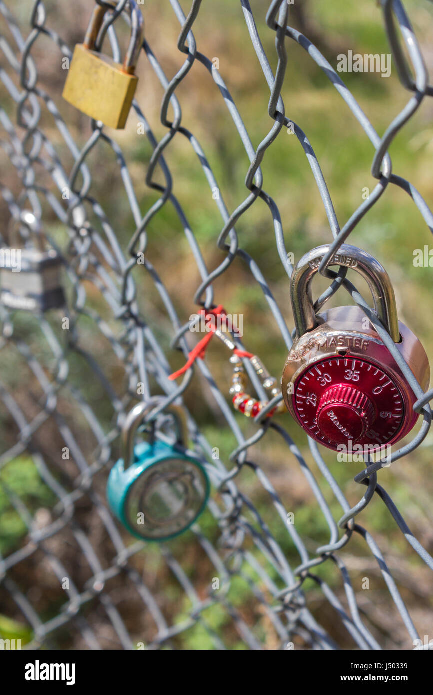 Locks hanging on a bridge fence. Stock Photo
