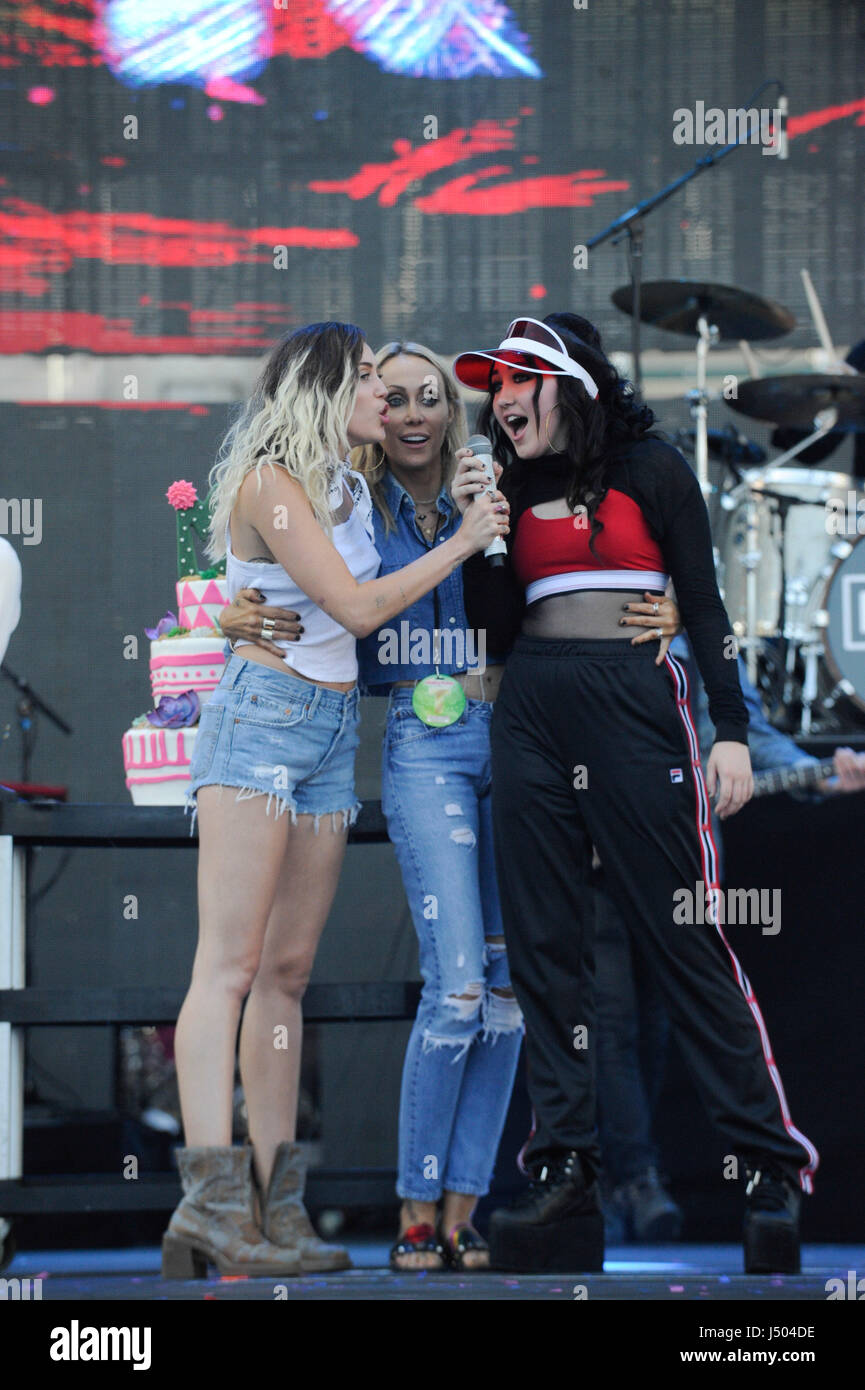 Miley Cyrus and Noah Cyrus on stage presenting a birthday cake to their mom Tish Cyrus at the 2017 KIIS FM Wango Tango at the StubHub Center on May 13, 2017 in Carson, California. Stock Photo