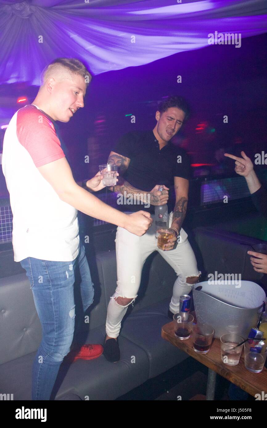 Watford, UK. 14th May, 2017. Exclusive Stephen bear makes lewd gesture with bottle of vodka as he parties with girlfriend Charlotte Crosby and friends in VIP area of Hydeout nightclub in Watford, UK. The couple stayed until 3am downing shots and drinks and dancing. Charlotte suffered a wardrobe malfunction and danced barefoot. Stephen posed for photos with fans but charlotte declined requests but still joined them on dancefloor. The couple were seen passionately kissing throughout the night. Credit: Ayeesha Walsh/Alamy Live News Stock Photo