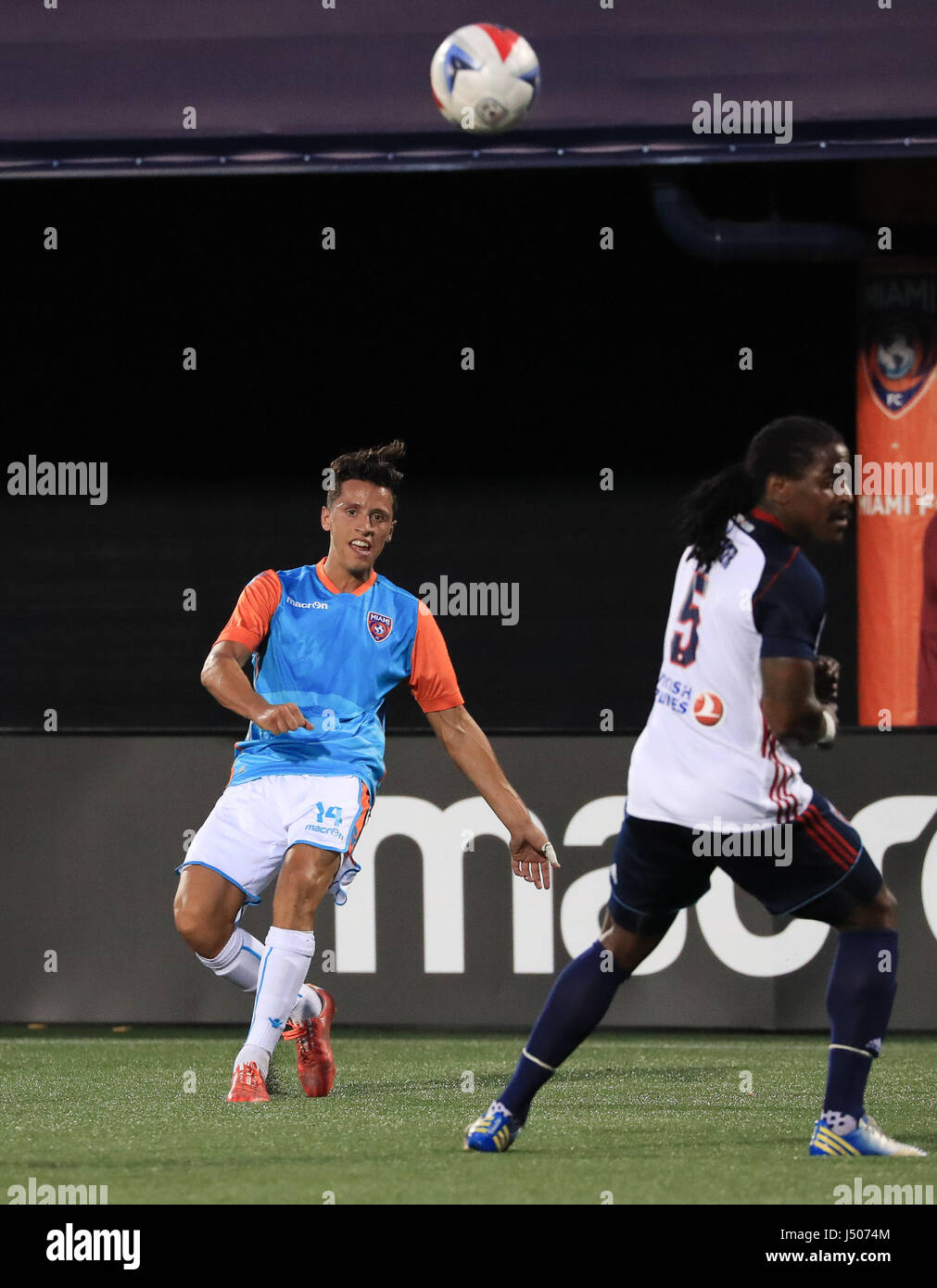Miami, Florida, USA. 13th May, 2017. Miami FC midfielder Robert Baggio Kcira (14) takes a shot past Indy Eleven defender Lovel Palmer (5) during the first half a North American Soccer League game between Indy Eleven vs Miami FC at the Riccardo Silva Stadium in Miami, Florida. Miami FC won 3-2. Credit: csm/Alamy Live News Stock Photo