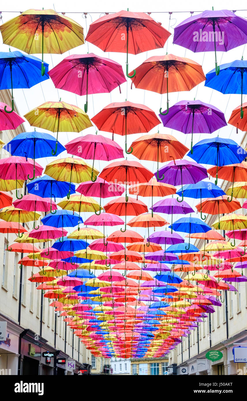 Bath, UK. 15th May, 2017. UK Weather. A drizzly wet day in Bath. Shoppers stop to look at the timely installation of colourful umbrellas. Credit: Mr Standfast/Alamy Live News Stock Photo