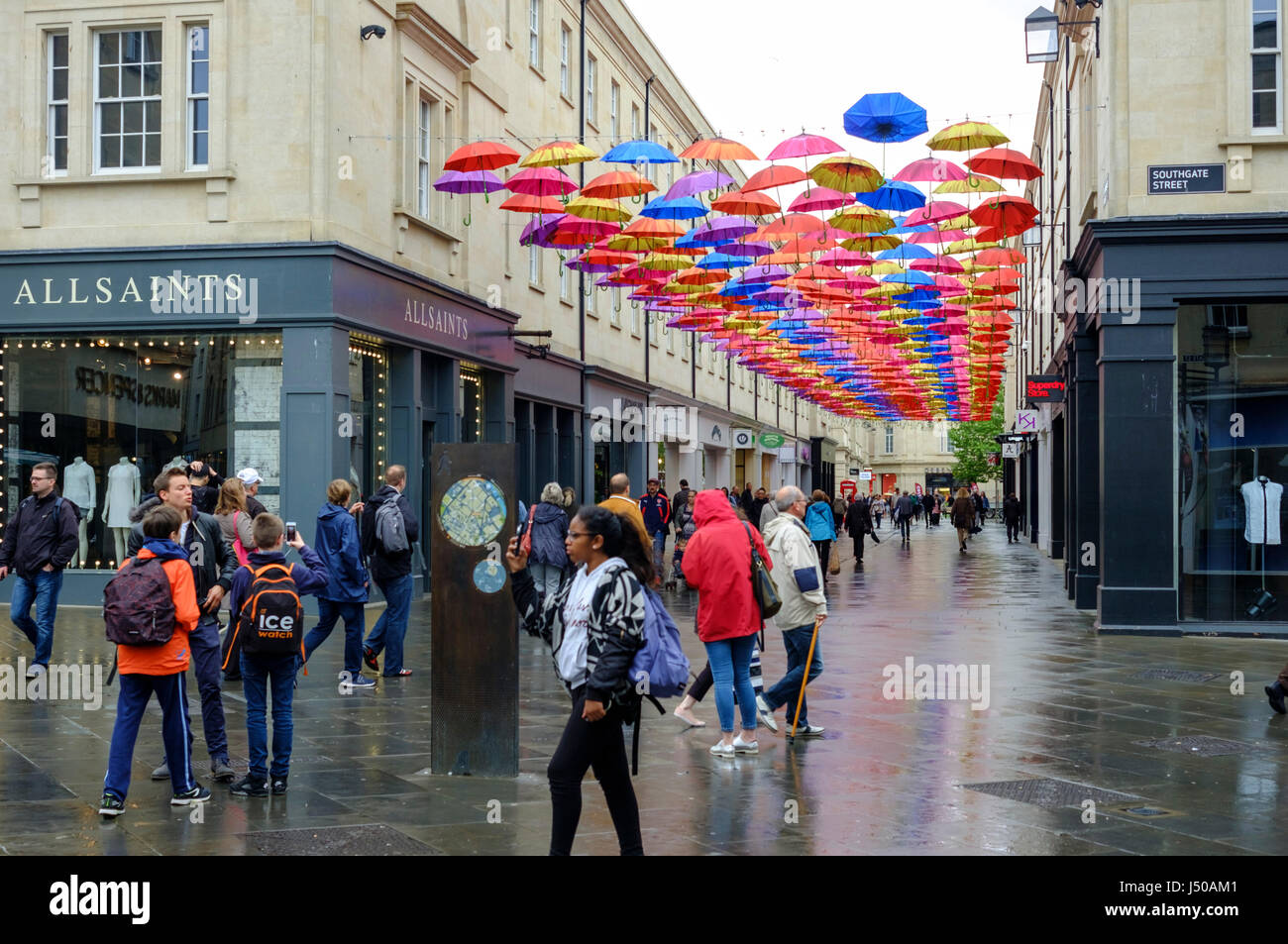 Bath, UK. 15th May, 2017. UK Weather. A drizzly wet day in Bath. Shoppers stop to look at the timely installation of colourful umbrellas. Credit: Mr Standfast/Alamy Live News Stock Photo