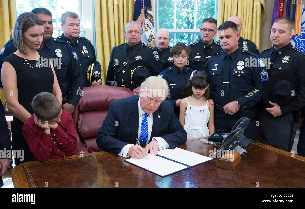 Washington, USA. 15th May, 2017. United States President Donald J. Trump, surrounded by men and women in uniform, about violence against police and signs a proclamation supporting police officers at The White House in Washington, DC, May 15, 2017. Credit: MediaPunch Inc/Alamy Live News Stock Photo