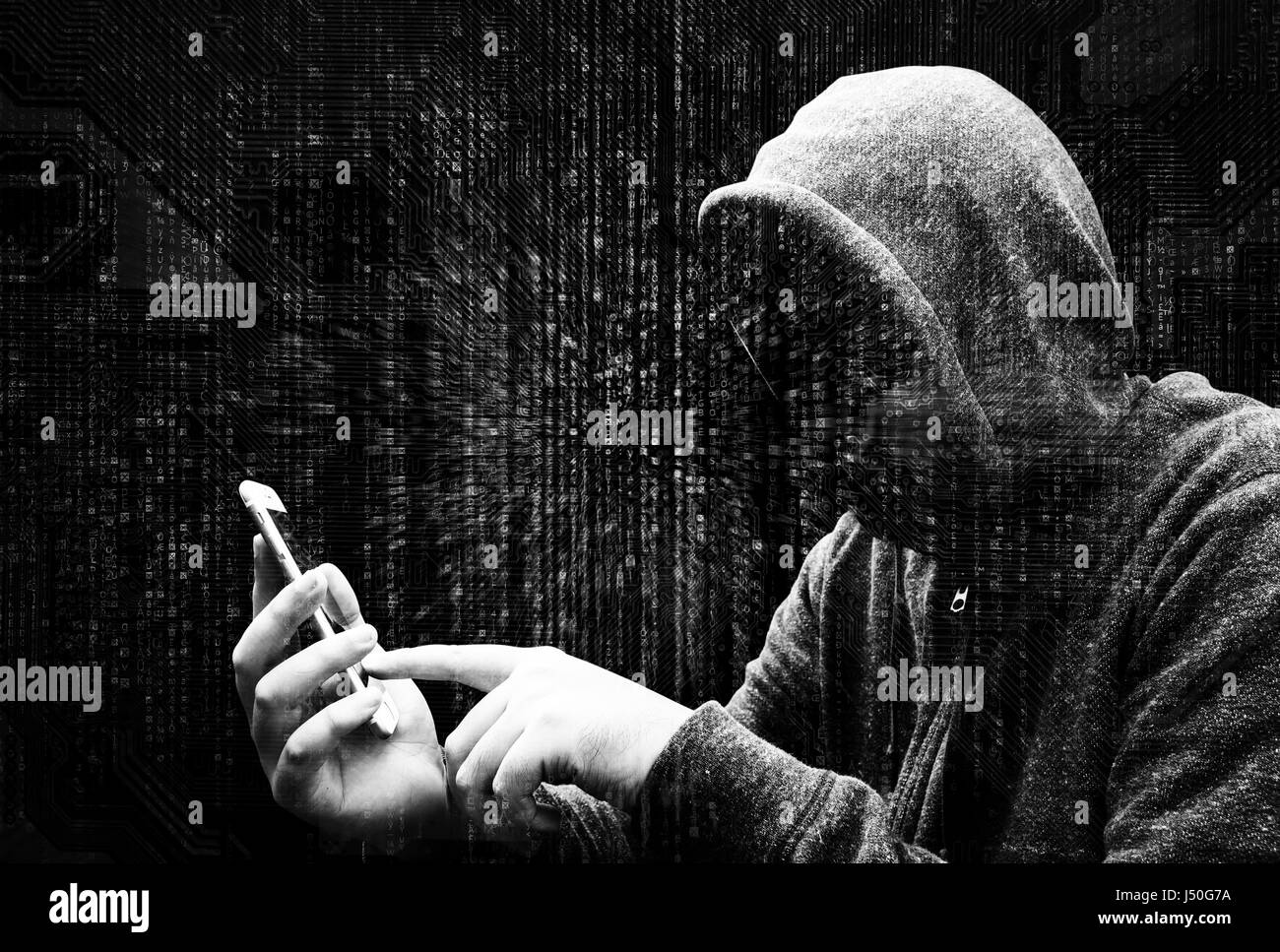 Double Exposure of hooded cyber crime hacker using mobile phone internet hacking in to cyberspace,online personal data security concept.Matrix code ba Stock Photo