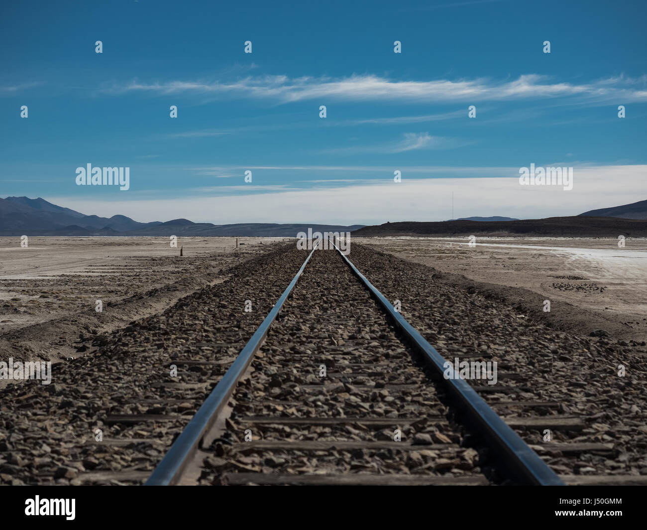 Straight railway through Atacama Desert, near Uyuni Salt Flats, Bolivia, South America. Stock Photo
