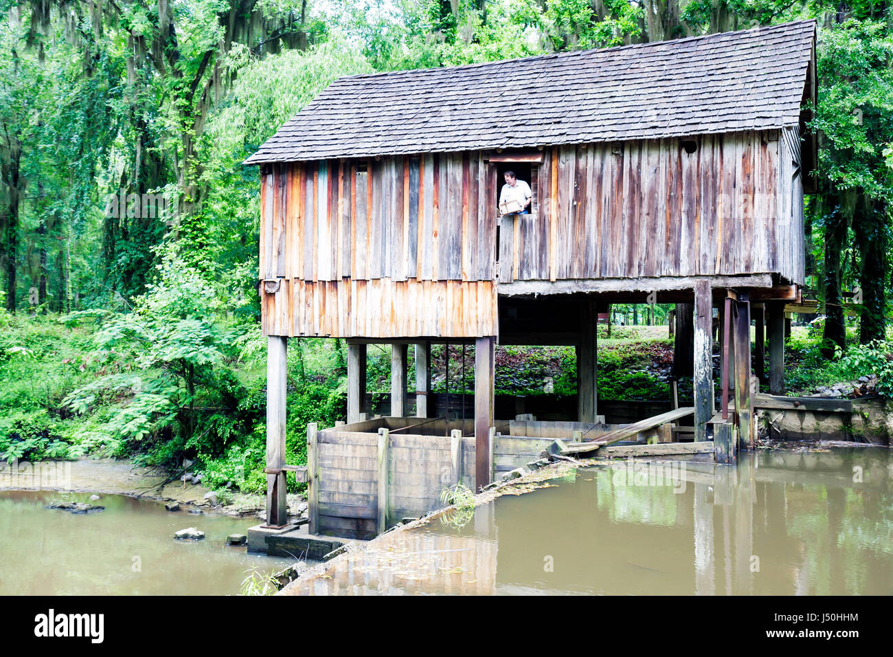 Alabama,Beatrice,Rikard's Mill,water powered grain mill,museum,built 1845,man men male adult adults,Flat Creek,wood,grinding,board & batten,under new Stock Photo
