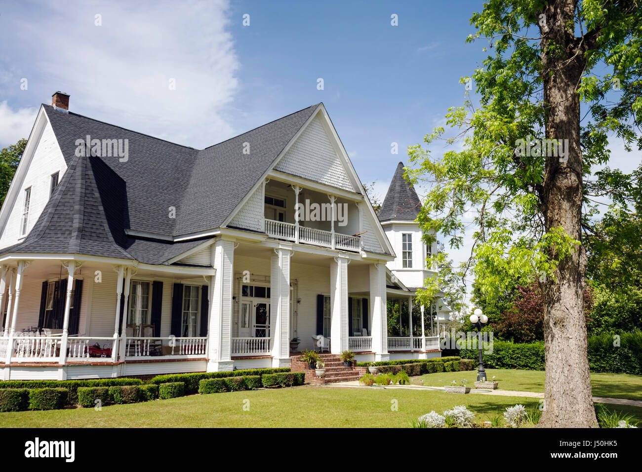 Monroeville Alabama,Pineville Road,historic homes,Hybart home,Queen Anne style,columns,wrap around porch,turret,gabled roof,front yard,tree,AL08051502 Stock Photo