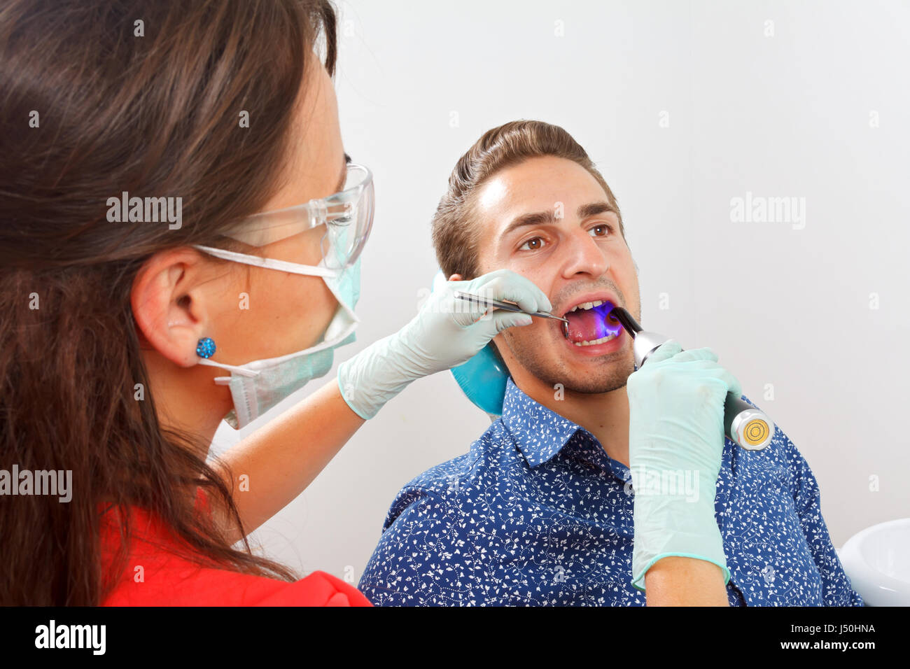The dentist is filling the patient's tooth Stock Photo Alamy