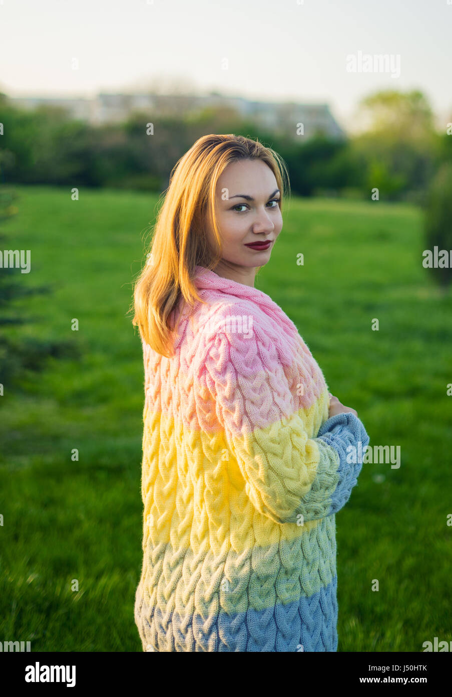 Pretty woman stands on the green grass lawn in the park Stock Photo - Alamy