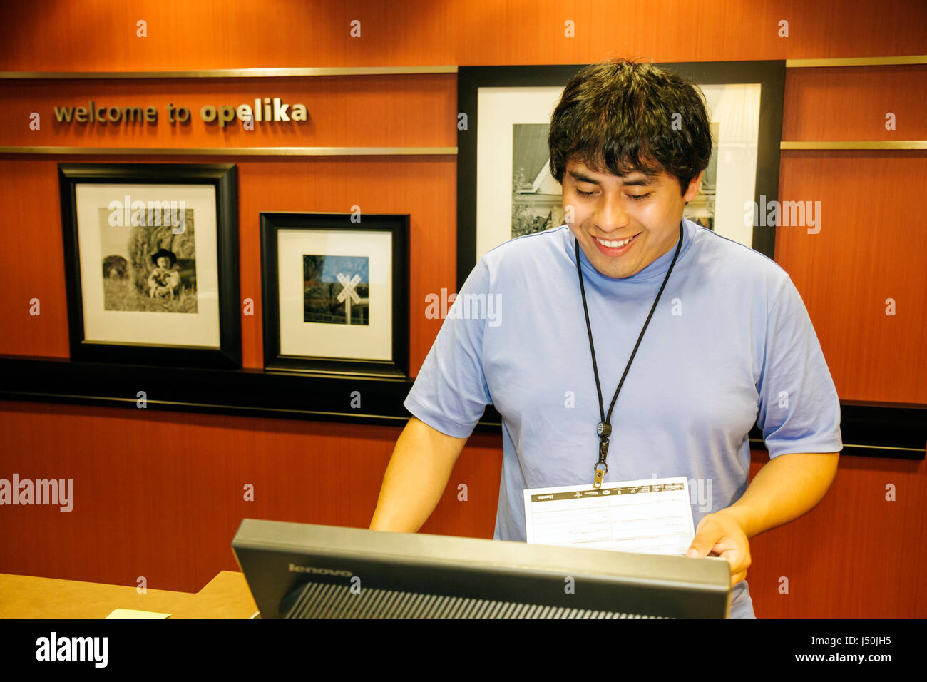 Alabama,Lee County,Opelika,Hampton Inn,& Suites,motel,Hispanic man men male adult adults,hotel desk clerk,customer service,lodging,hospitality,registe Stock Photo