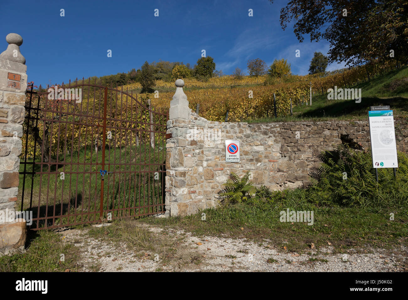 Stone wall with iron gate at Corno di Rosazzo, Friuli, Italy Stock Photo