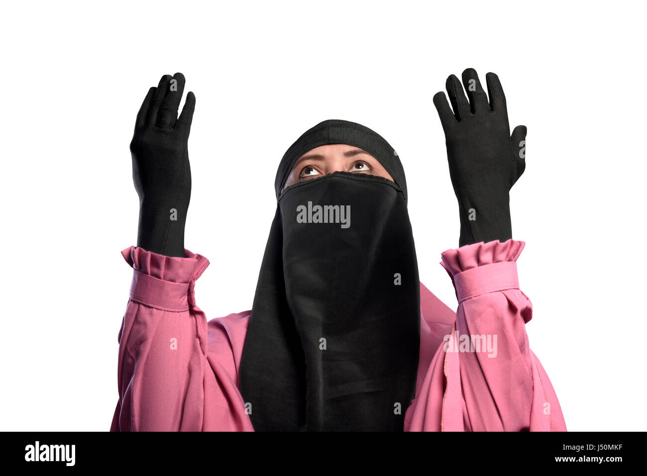 Young asian muslim woman wearing niqab praying to god isolated over white background Stock Photo