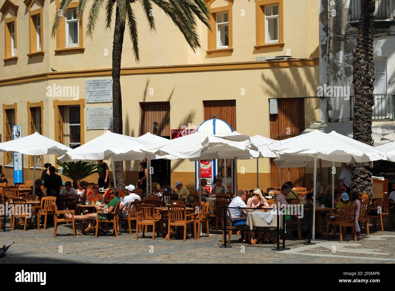 Tourists relaxing at pavement cafes in Cathedral Square, Cadiz, Cadiz Province, Andalusia, Spain, Western Europe. Stock Photo