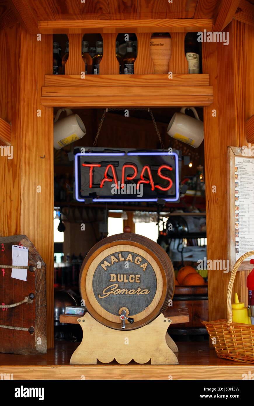 Tapas sign and a Malaga sweet wine barrel at a beach bar, Torremolinos, Malaga Province, Andalusia, Spain, Western Europe. Stock Photo