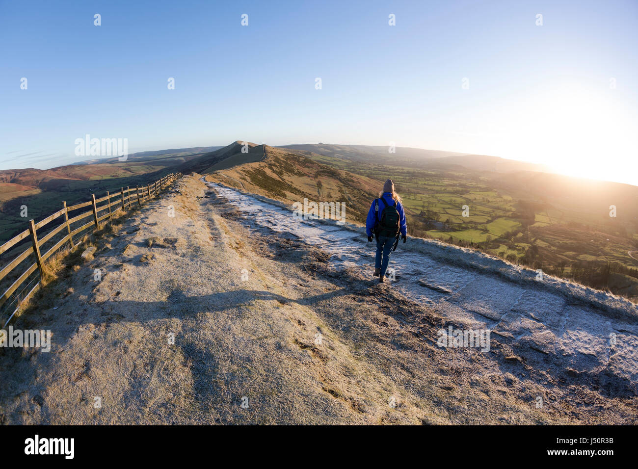 A walker on the Mam Tor ridge at sunrise. Stock Photo