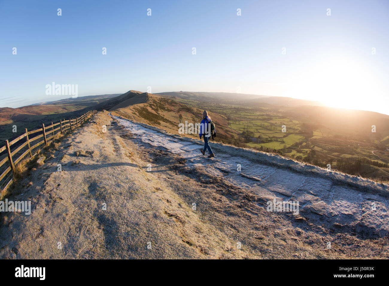 A walker on the Mam Tor ridge at sunrise Stock Photo - Alamy