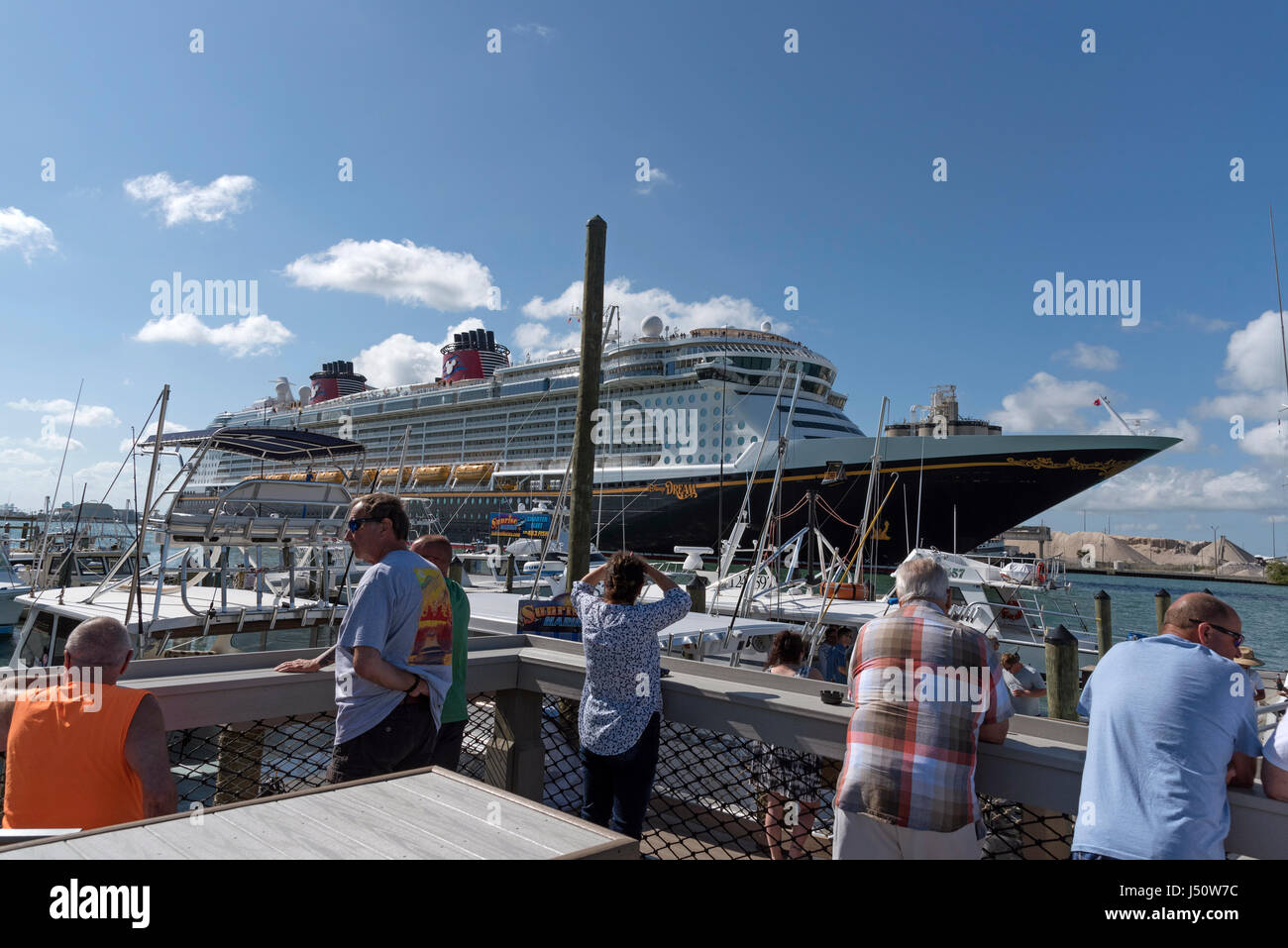 Holidaymakers watch as the Disney Dream cruise ship departing Port canaveral Florida USA. April 2017 Stock Photo