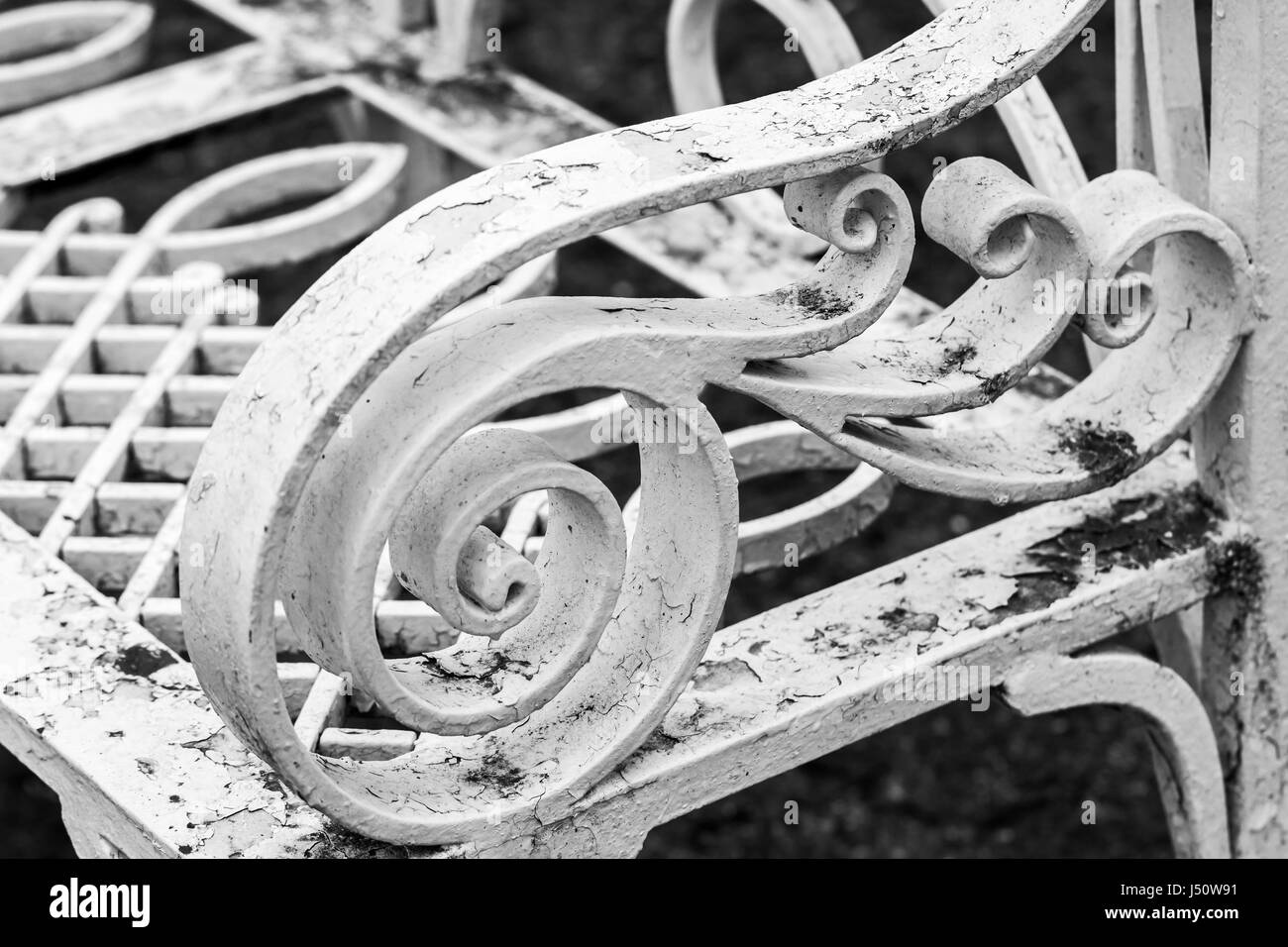 Vintage metal park bench with white decorative forged pattern Stock Photo