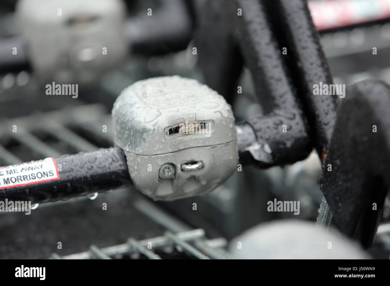 A shopping trolley's coin receiver at a Morrisons super market Stock
