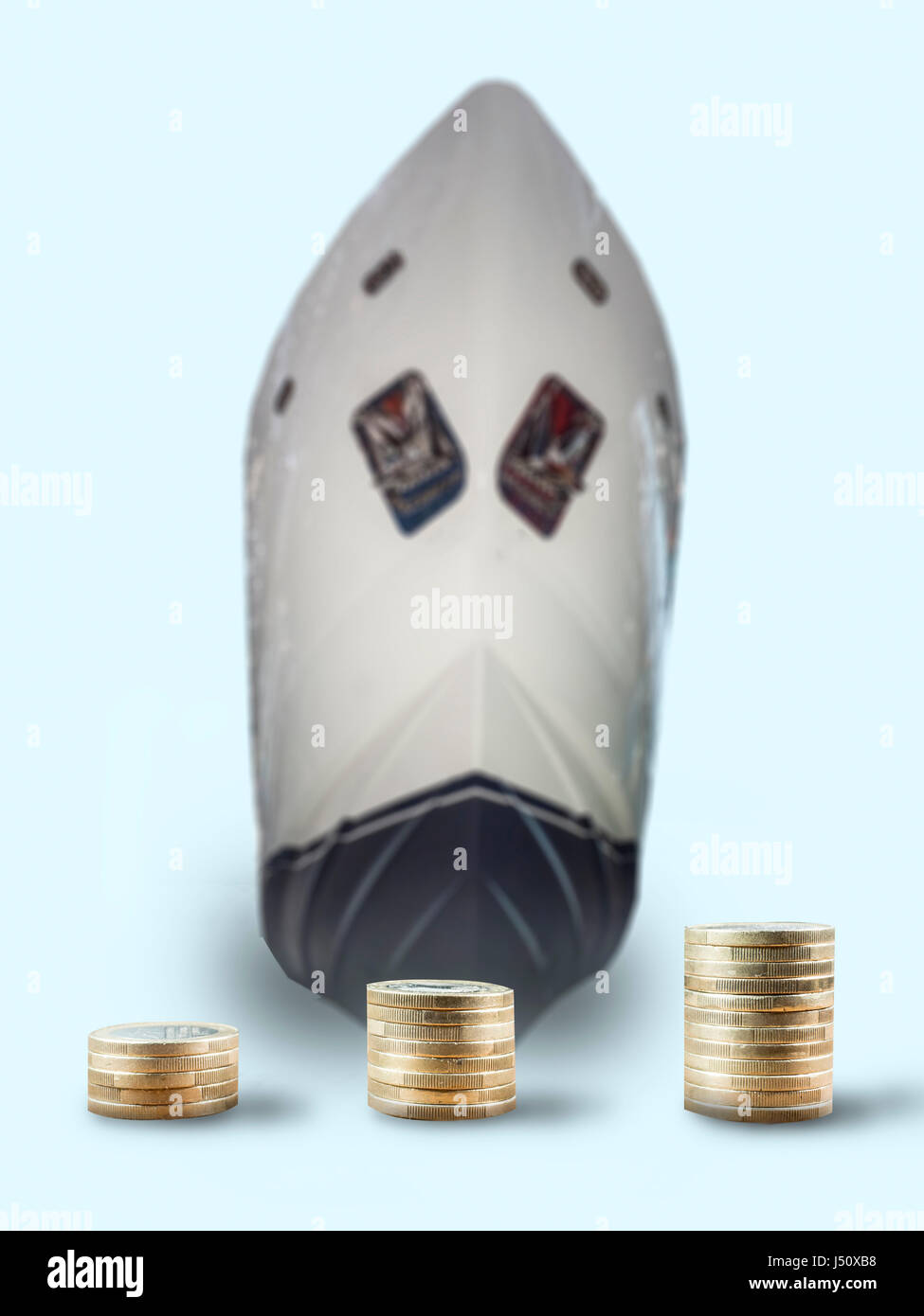 coin stacks in front of a ship Stock Photo