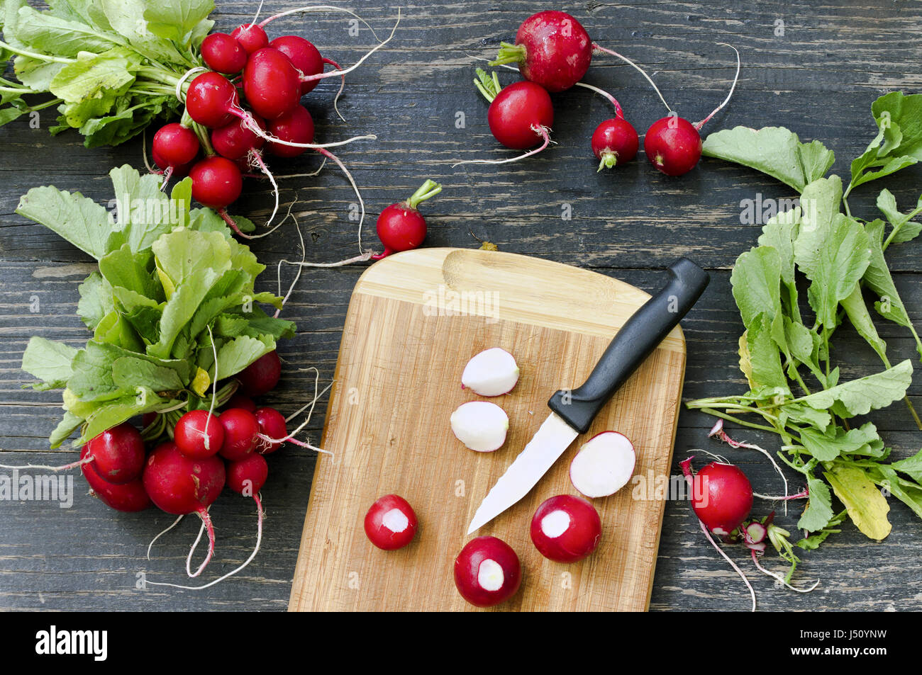 Fresh red radishes on a cutting board Stock Photo