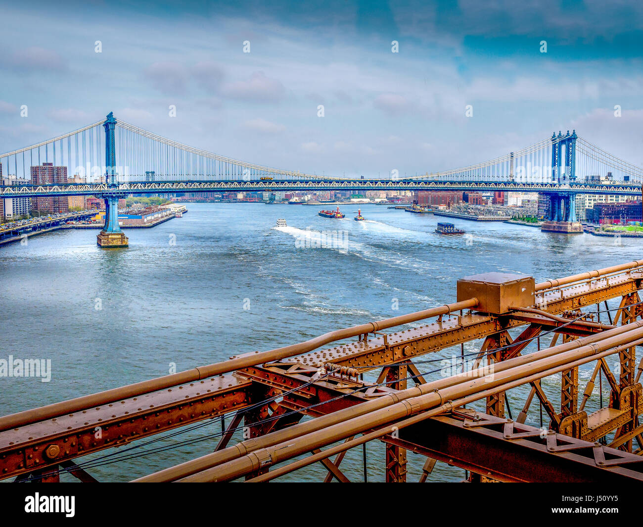 The Manhattan Bridge from the pedestrian walkway over the Brooklyn Bridge. Stock Photo