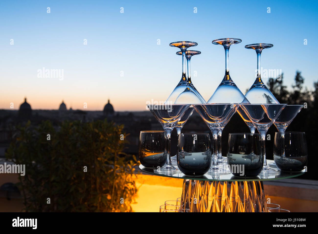 Tower of stem glasses view at sunset with city skyline in background, Rome dome Stock Photo