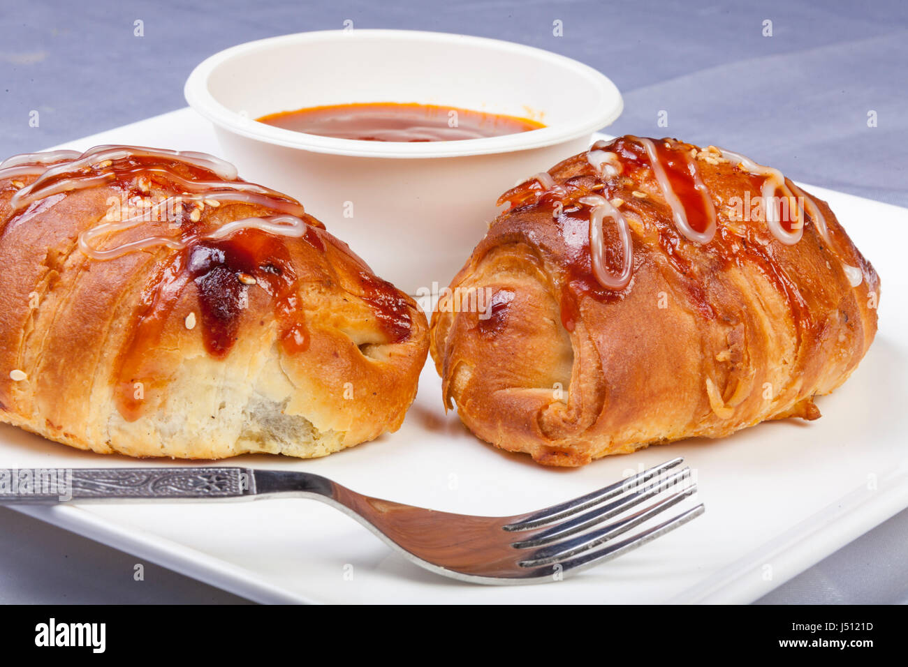 Baked Pastries and Namkeen as evening snacks with tomato ketchup Stock