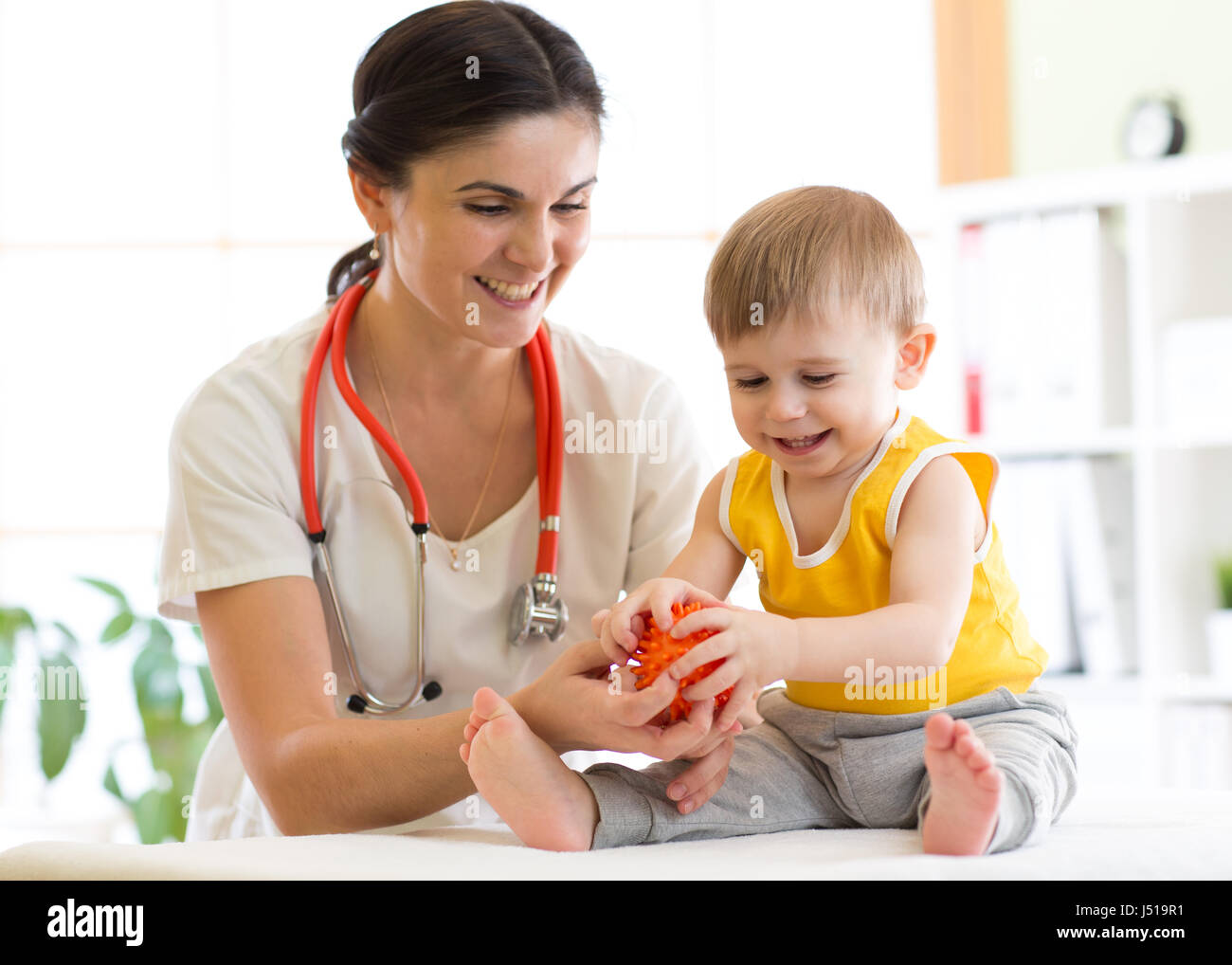 Doctor doing massage to little patient using a ball Stock Photo