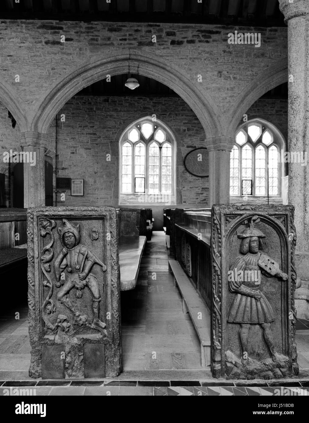 Examples of distinctive Tudor bench ends in St Nonna's Church, Altarnun, Cornwall, carved by Robart (sic) Daye between 1510 & 1530: jester & fiddler. Stock Photo