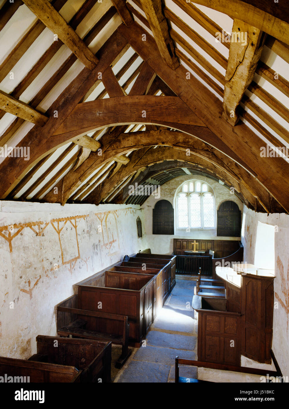 Interior of Llangar Old Parish Church looking E from the musician's gallery showing roof timbers, Medieval wall paintings & early C18th furnishings. Stock Photo