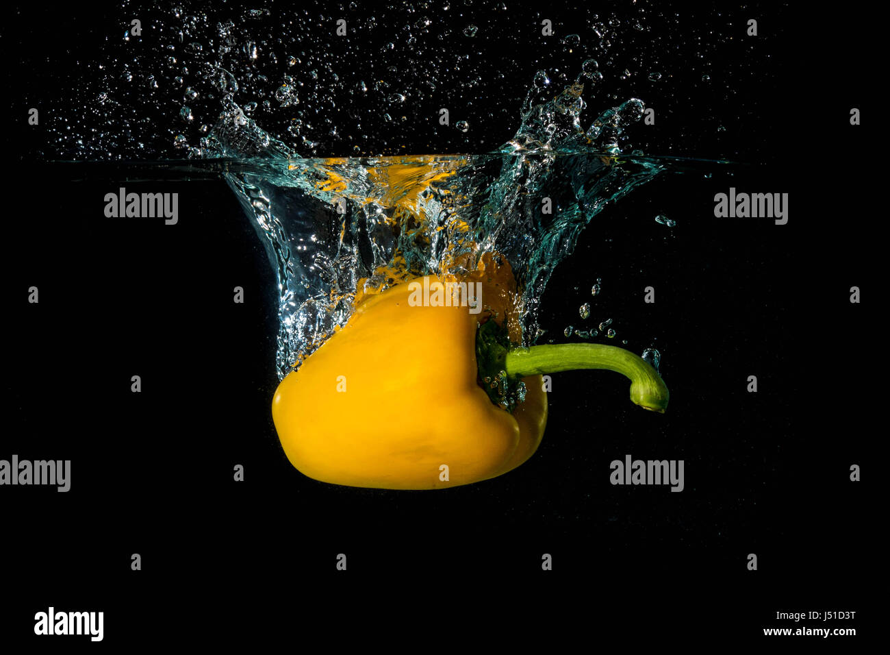 Yellow Bell Sweet Pepper Droped Into Water Stock Photo