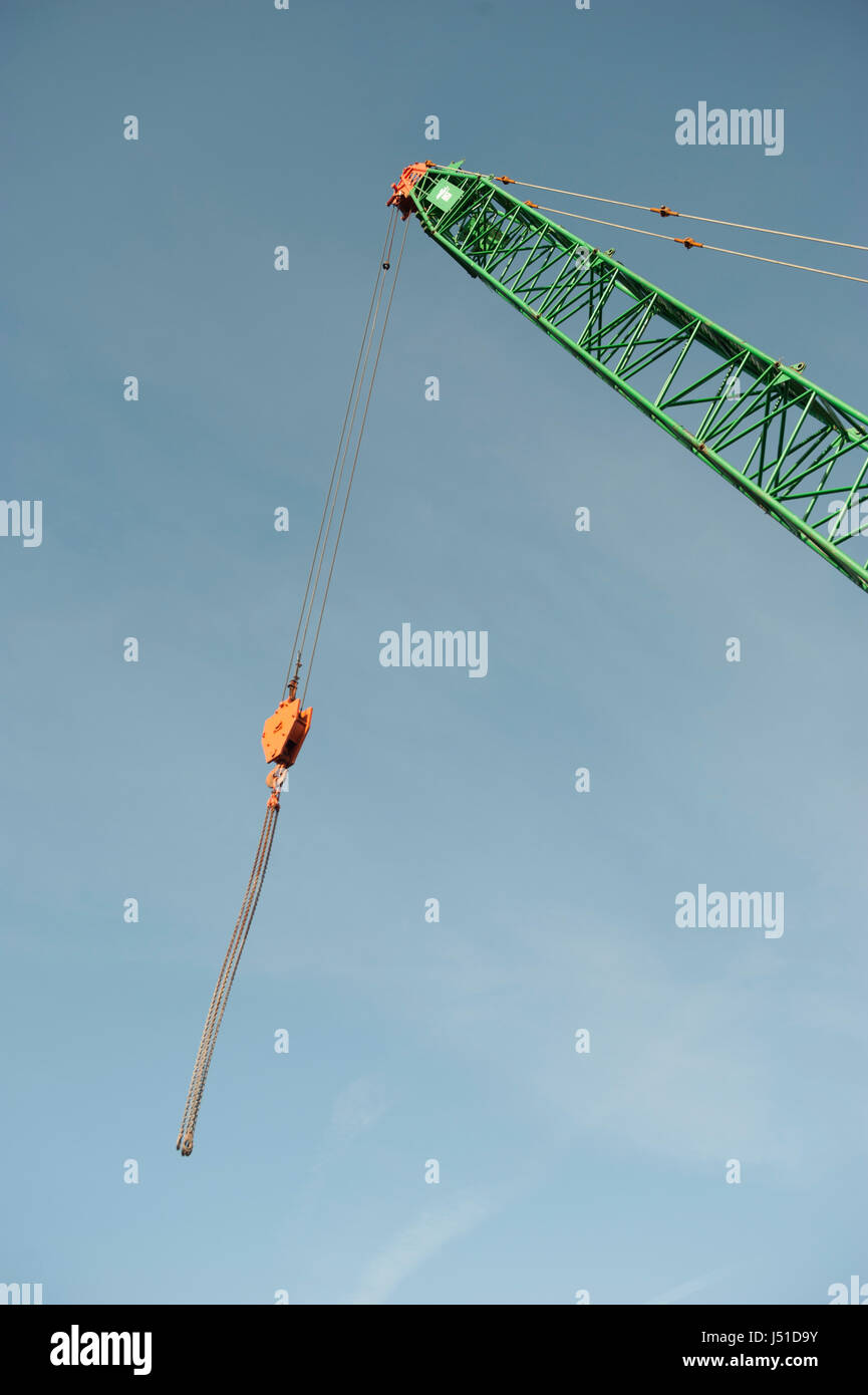Crane jib extended into the sky air with copy space blue sky background. Stock Photo