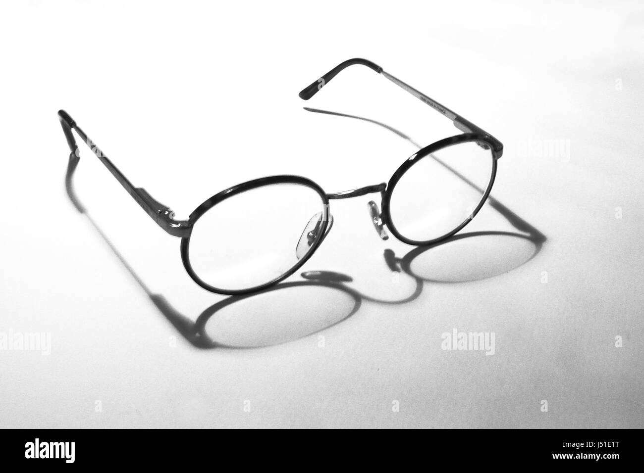 spectacles glasses eyeglasses shaddow shadow shadows brillengestell schwarz-wei Stock Photo