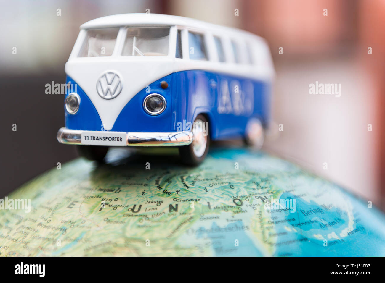 Concept of a world trip with globe and Volkswagen T1 Transporter van crossing the planet Stock Photo