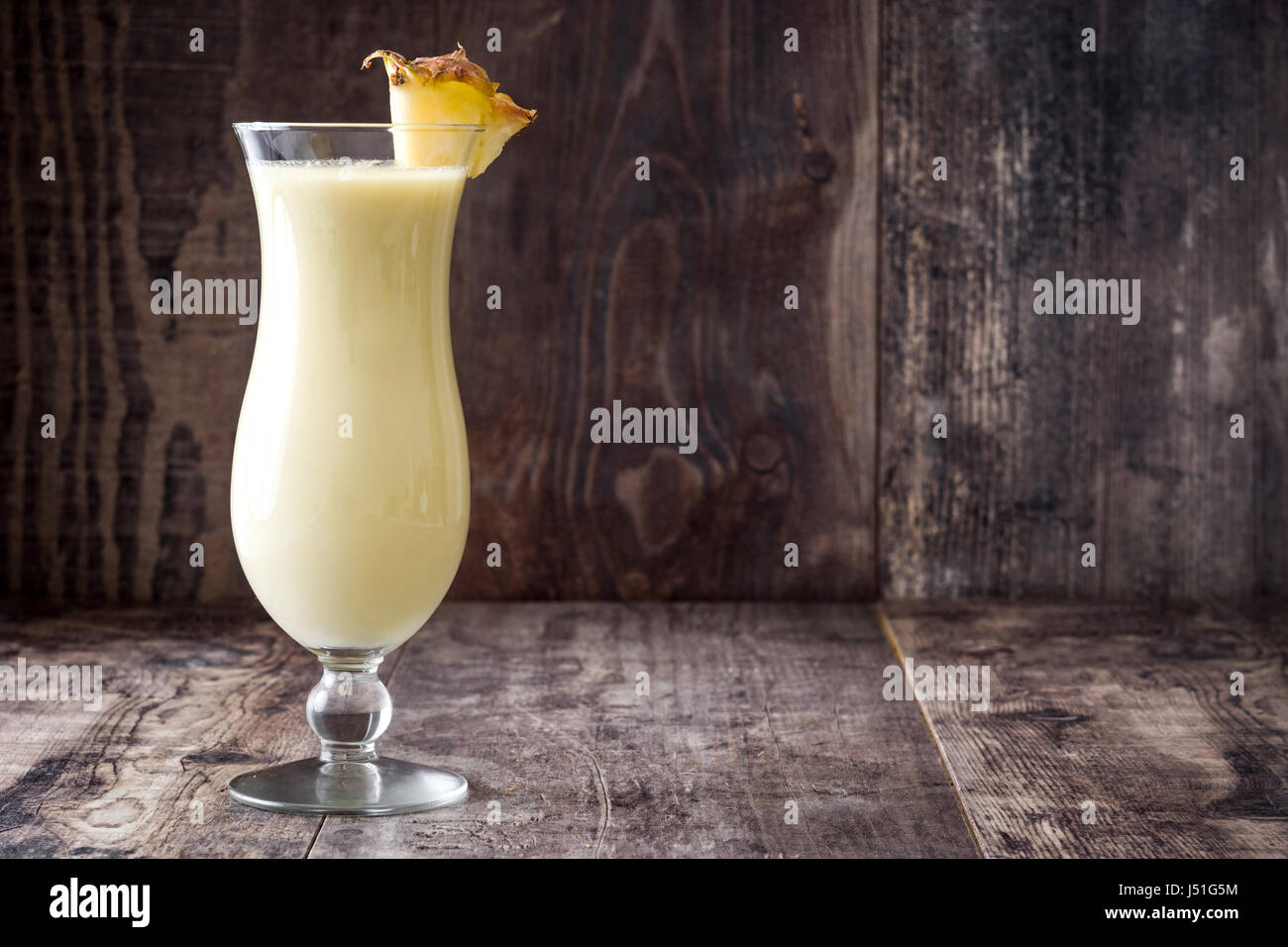 Pina colada cocktail on wooden background Stock Photo