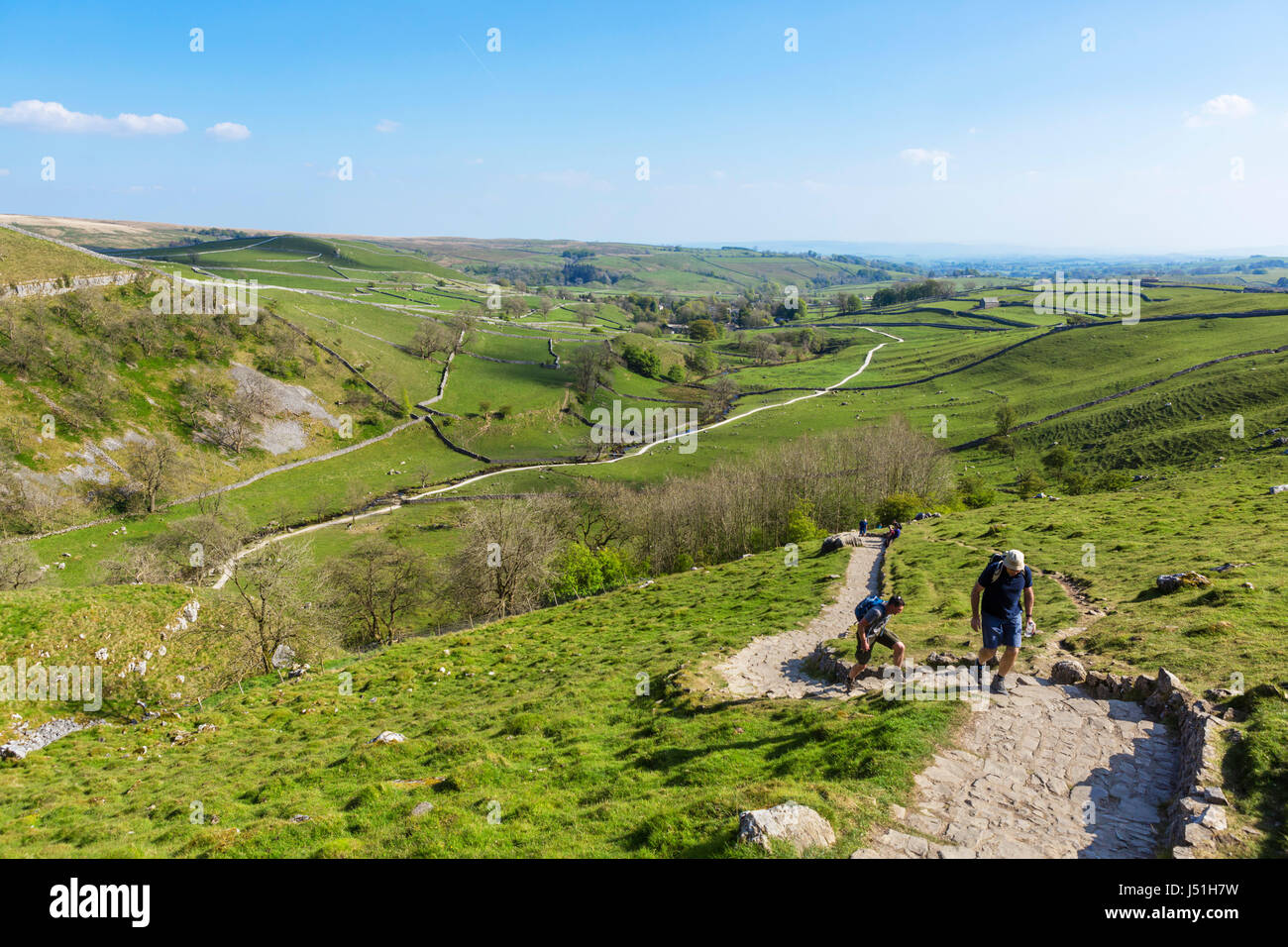 Walkers on the climb up to the top of Malham Cove, Malham, Malhamdale, Yorkshire Dales National Park, North Yorkshire, England, UK. Stock Photo
