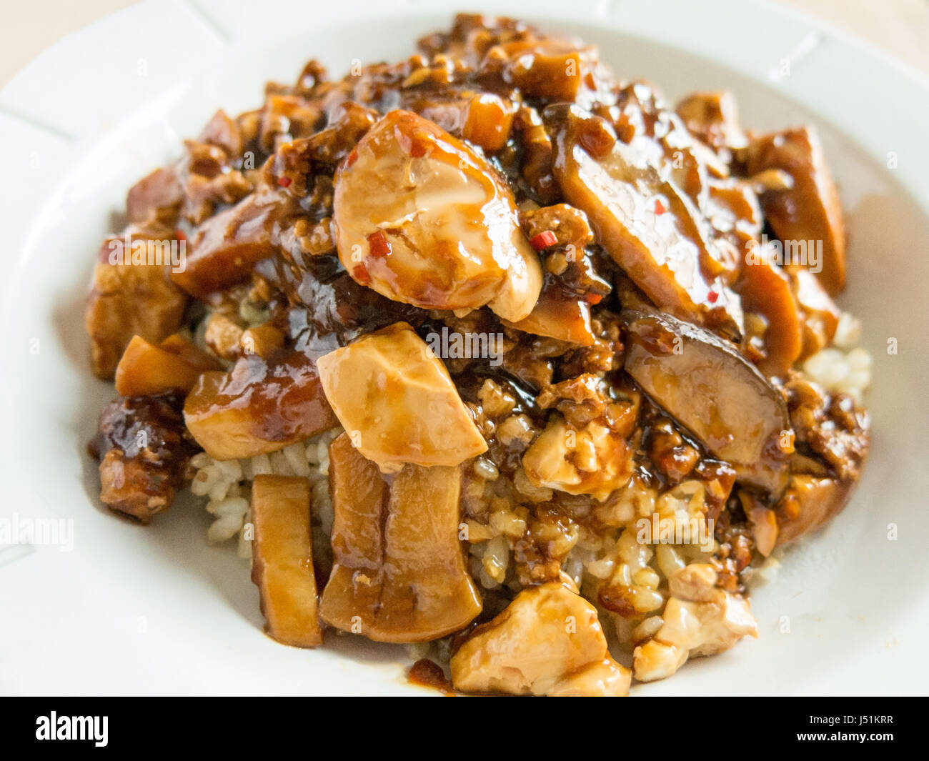 Spicy Mapo Tofu with ground pork and mushroom on jasmine brown rice Stock Photo