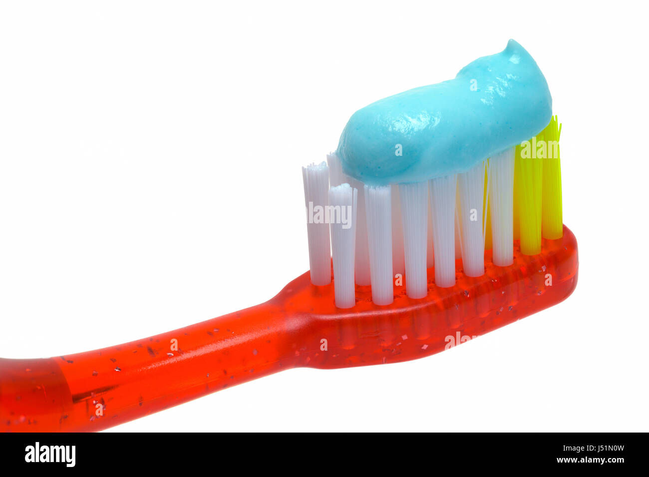 Close Up of Red Toothbrush with Toothpaste Isolated on White Background. Stock Photo