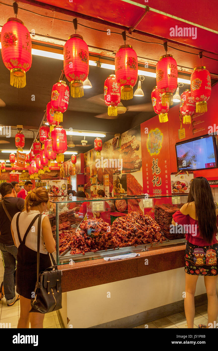 A Chinese vendor's streetside shop is filled with varieties of pork and