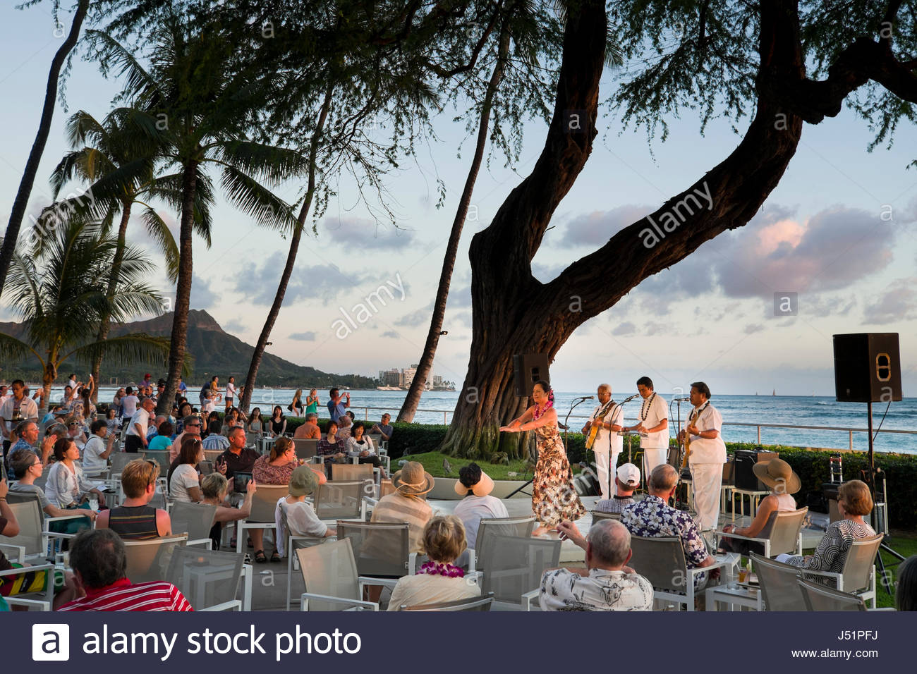 Hawaiian Musicians And Female Hula Dancer Entertain Patrons Under A Stock Photo Alamy