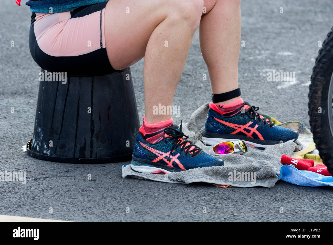 Female competitor wearing Asics running shoes, transition area, Stratford Triathlon, UK Stock Photo